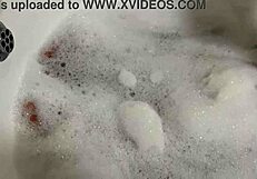 The brunette with long hair sings and masturbates in the shower