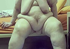 Obese middle aged lady flaunts assets on the camera