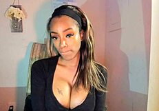 Tattooed ebony milf with huge nipples and large buttocks touches her breasts and rubs her genitals