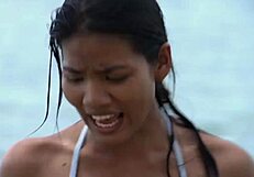 This is Islander beauty in a revealing swimsuit by the sea