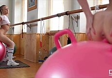 Milana Blanc, a fitness model, happily sits on a rubber penis sex toy for fun during exercise