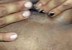 A latina woman stripped half naked and starts to get herself wet and rub her big fat pussy
