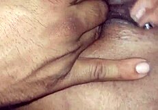 A latina woman stripped half naked and starts to get herself wet and rub her big fat pussy