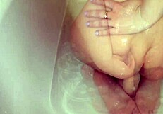 A young amateur girl enjoys sex toy shower play and fingering to squirting