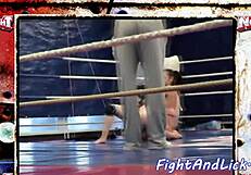 Two European women struggling in a boxing ring