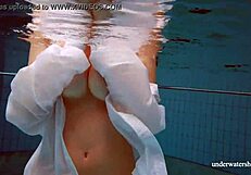 Blonde beauty wearing bikini – attractive woman playing with water in public swimming pool