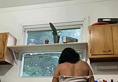 A exotic beautiful Latin woman in her later years seems to enjoy cleaning the house