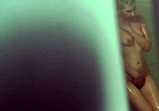 Emily takes a steamy shower, unaware of voyeur eyes watching her.
