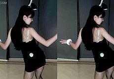 Pretty Chinese girl dancing and teasing in cam show.