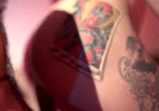 A tattooed MILF gives a blowjob and gets fucked by her attached boyfriend