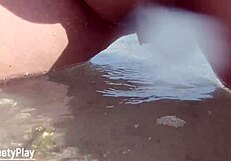 A big curvaceous MILF enjoys urinating outdoors on a public beach