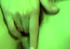 A sexy young woman undresses and pleases herself