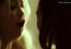 Two women with blonde hair and tattoos have sex instead of watching a horror movie