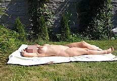 I have been spying on my stepmother and she is sunbathing naked in the yard