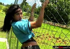 Dark-haired Latina shemale shows off her big tits and strokes her monster cock on the soccer field