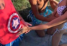 Beautiful brunette gets it from three friends in the park
