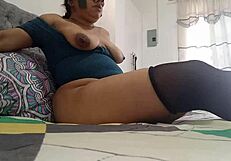 Sexy brunette gives herself a sensual massage and caresses her boobs