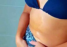 beautiful tanned latina girls showering after a beach day together